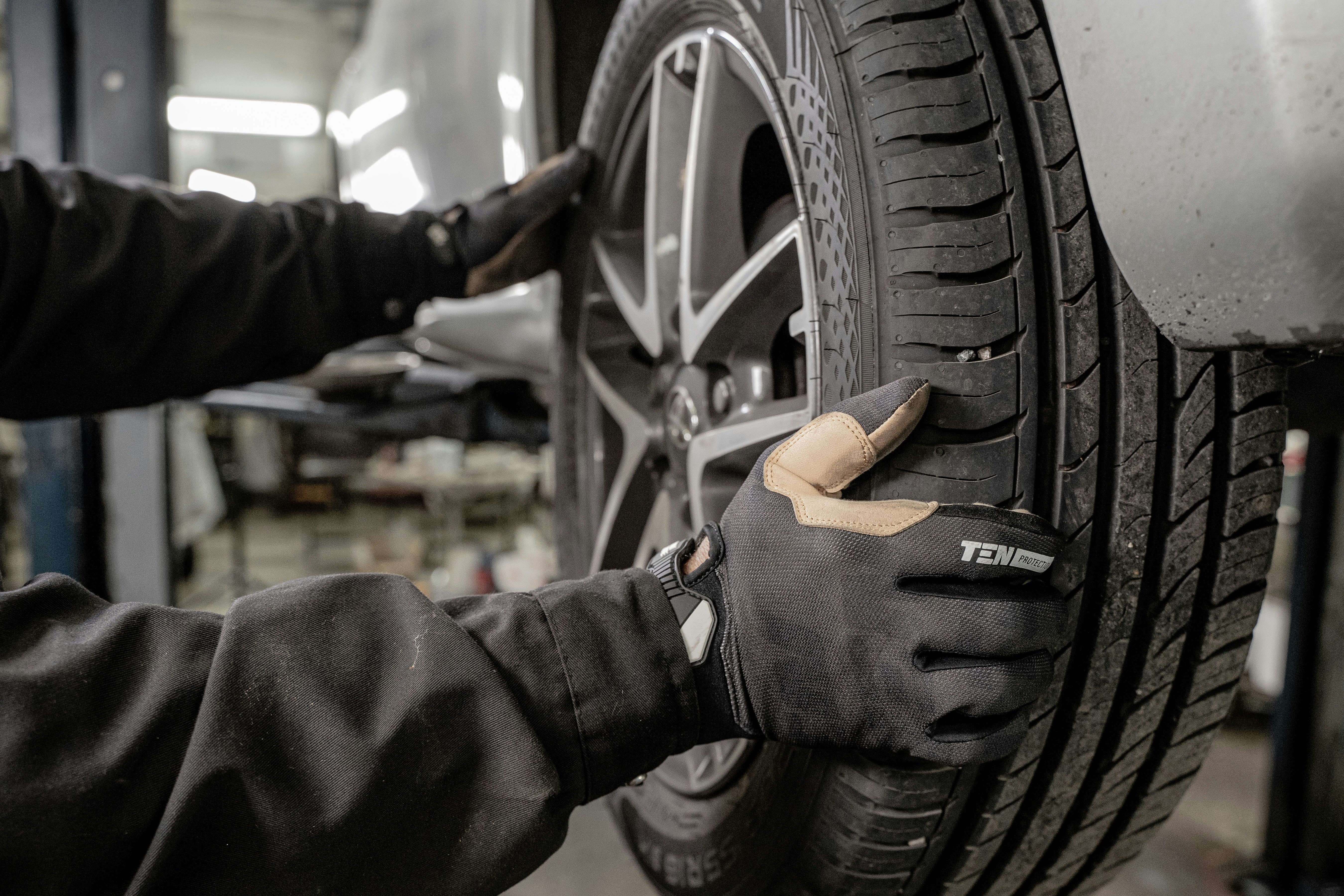 Image of a Car Wheel being put on by a Technician